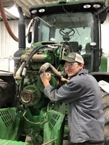 Service technician works on a tractor